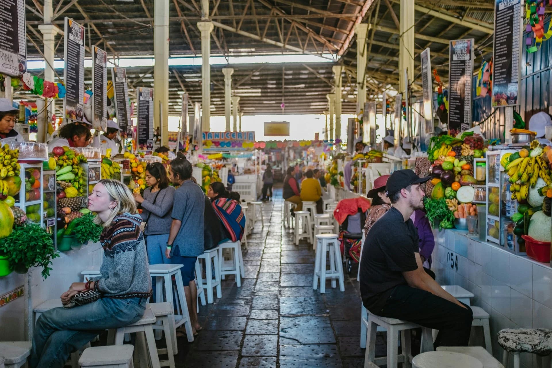 Plate of fresh Peruvian ceviche with red onion and choclo at a Lima market stall