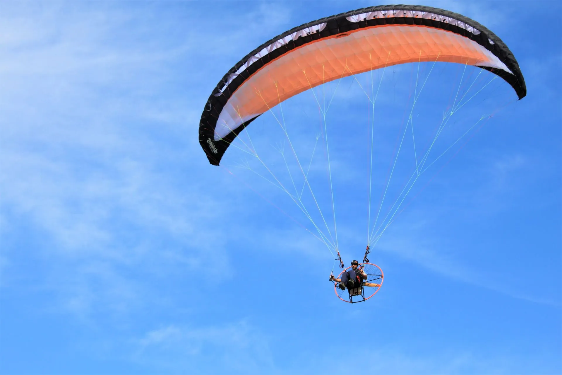 Tandem paraglider flying above the Costa Verde cliffs and Pacific Ocean on the Lima coastline