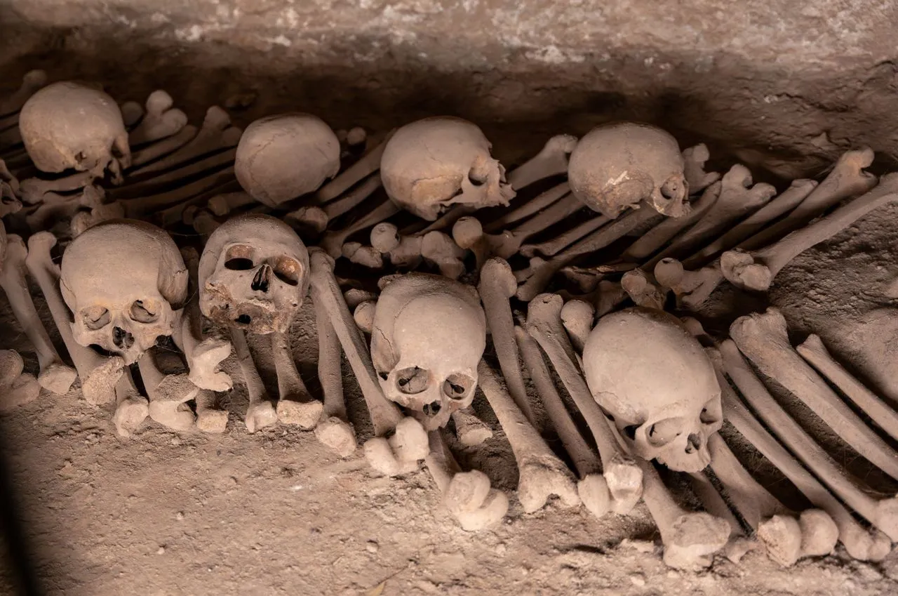 Ancient catacombs in Lima containing human skulls and bones arranged in a stone crypt