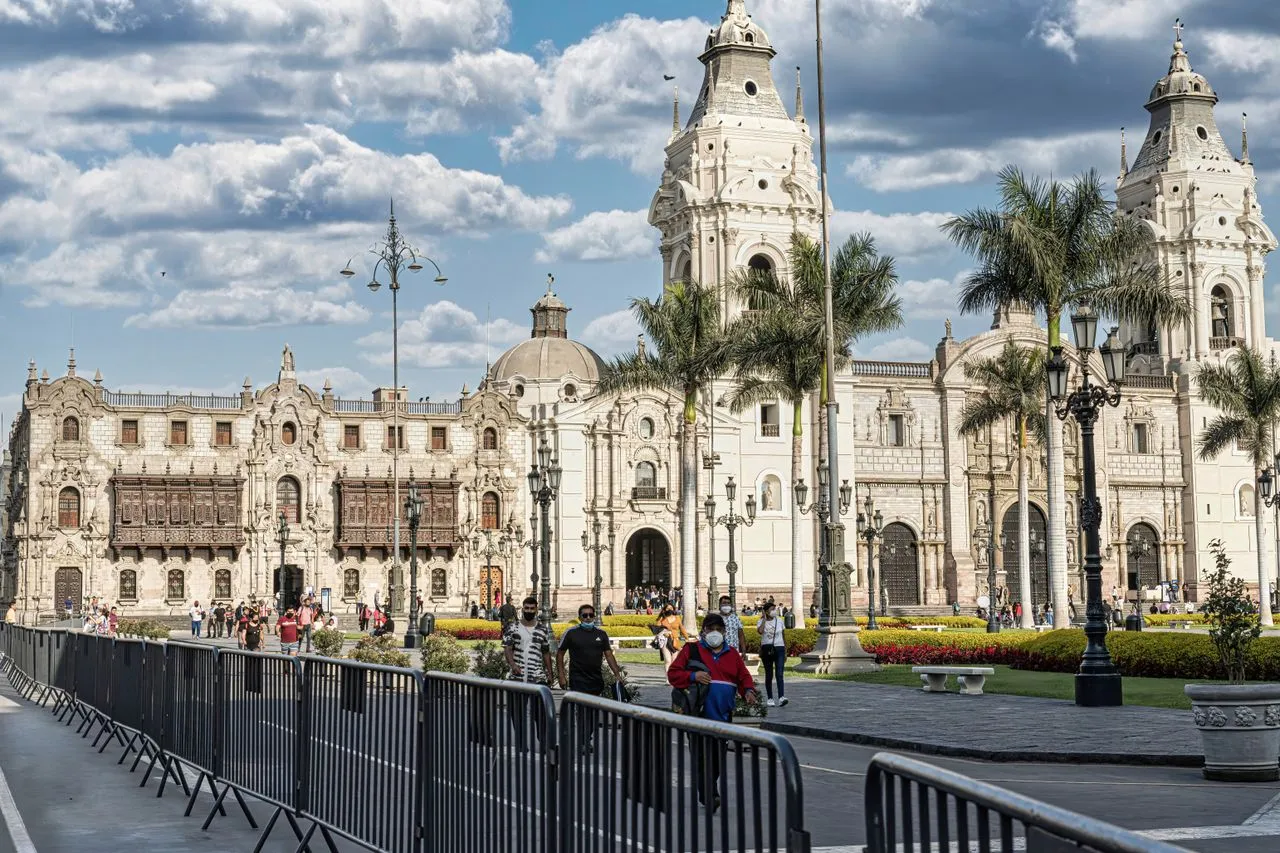 The stone facade and twin bell towers of Lima Cathedral on Plaza Mayor in the historic centre